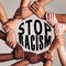 It stops with us. unrecognizable people linking arms and encircling the words stop racism against a gray background.