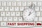 Stopwatch on a keyboard with text Fast Shipping and a truck