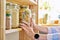 Storage of food in the kitchen in pantry, woman& x27;s hands with jar of colored paste