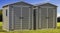 Storage sheds on green lawn and blue sky background. 3d illustration