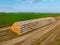 Storage of straw bales on harvested wheat field at sunset