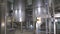 Storage Tanks in Brewery. Brewing factory indoors. Steadycam shot.