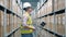 Storage worker in safety wear is registering parcels