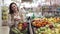 Store opening, portrait of a beautiful smiling woman with a grocery basket in her hands buys ecological vegetables and