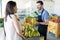 Store Owner Promoting Healthful Fruits In Shop