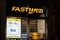 The storefront of the Fastweb telecommunication provider rduring the night