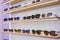 Storefront shelves of various modern sunglasses at the airport`s retail store