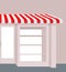 Storefront with striped roof. Red and white stripes of canopy over counter. Element of building.