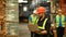 Storehouse employees workers in hardhats and and vests working together in warehouse. Logistics, and manufacture