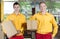 Storekeepers holding boxes in warehouse