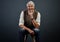 The stories I could tell...Studio portrait of a handsome mature man looking thoughtful while sitting on a stool against