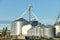 Storing grain in a group of corrugated steel granaries.