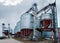 Storing grain in a group of corrugated steel granaries. Point of cleaning, drying and storage of cereals. agro granary in spring