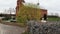 A stork sits in a nest against the backdrop of a church. View from the drone.