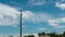 Stork Sits on a Pole in the Village and Moving Clouds. Time lapse