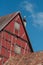 Stork standing on chimney of alsacian medieval house on blue sky background