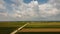 Storm above a agricultural plain country road