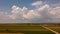 Storm above a agricultural plain country road