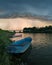 Storm arcus shaft and cumulonimbus cloud with heavy rain or summer shower, severe weather and sun glow behind rain. Landscape with