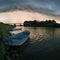 Storm arcus shaft and cumulonimbus cloud with heavy rain or summer shower, severe weather and sun glow behind rain. Landscape with