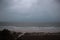 Storm on the beach. The seas are raging and the skies show the tropical storm as the power of nature is demonstrated. palm tree pu