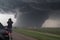 storm chaser documenting tornado& x27;s destructive path by taking photos and videos