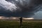 storm chaser in the eye of the storm, surrounded by swirling clouds and rain