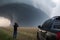 storm chaser filming tornado from the safety of their vehicle