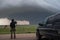 storm chaser following funnel cloud as it touches down and causes damage