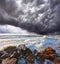 The storm cloud over the raging surf
