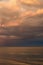 Storm clouds on the Azov Sea, illuminated by the setting sun, the sea horizon