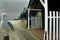 Storm clouds on the beach. Beach huts with a seagull on sentry duty