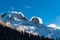 Storm clouds blowing over snow covered alpine peaks in winter