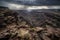 Storm clouds brewing over a rocky canyon with winding rivers adding drama to the rugged landscape