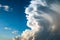 Storm clouds building up on blue sky