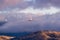 Storm clouds covering the top of Mount Hamilton, with Lick Observatory peeking through them; San Jose, South San Francisco Bay