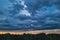 Storm clouds. Dramatic sky over city. Thunderstorm weather. Rain pours from cumulus clouds.