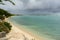 Storm clouds gather as a plane lands near a beach in Oranjestad, Aruba.