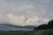 Storm clouds gather over lush farmland in the Highlands of Scotland.