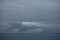 Storm clouds gathering over the deep blue waters of the Gulf of Alaska