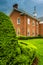 Storm clouds over bushes and a building at the Lutheran Seminary