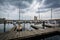 Storm clouds over docks and boats in Harbor East, Baltimore, Mar