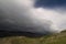 Storm clouds over farmland, New Zealand