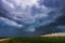 Storm clouds over field, tornadic supercell, extreme weather, dangerous storm