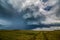 Storm clouds over field, tornadic supercell, extreme weather, dangerous storm