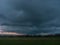 Storm clouds over fields.