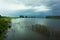 Storm clouds over marsh river