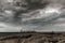 Storm clouds over open pit mine