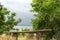 Storm clouds over the sea and the city.Old wooden bench against the background of the sea