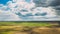 Storm Clouds And Whirlwind Tornado Above Empty Countryside Rural Field Landscape In Spring Cloudy Day. Agricultural